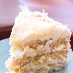This homemade Lemon Coconut Cake has layers of homemade lemon curd and lemon cream cheese frosting. The classic coconut cake recipe is given a lemon twist, making it the perfect recipe for a stunning spring dessert or easy Easter dessert!