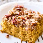 This easy pumpkin coffee cake recipe is full of sweet spices, rich pumpkin flavor, and topped with a pecan brown sugar crumb topping! This sweet fall breakfast treat is perfect when paired with a cup of coffee!