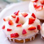 These homemade baked strawberry lemon donuts are sweet, tangy, and the perfect spring breakfast. This easy baked donut recipe is filled with fresh strawberries and topped with a lemon glaze. Plus, a step-by-step video! Yay.