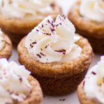 These easy S’mores Cookie Cups have all the flavors of the classic campfire dessert! This S’mores Cookie Cup recipes begins with a graham cracker cookie base, is filled with a sweet mocha marshmallow cream, and topped with whipped cream and chocolate shavings. This might just be your new favorite spring and summer dessert recipe! Plus a step-by-step video down below.